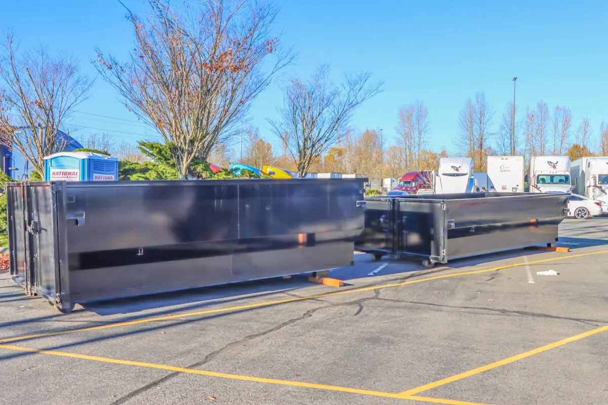 Professional dumpster rental service with roll-off container on residential driveway in Ogdensburg